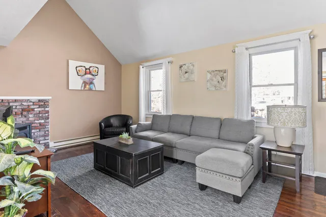 a living room with furniture a fireplace and a table