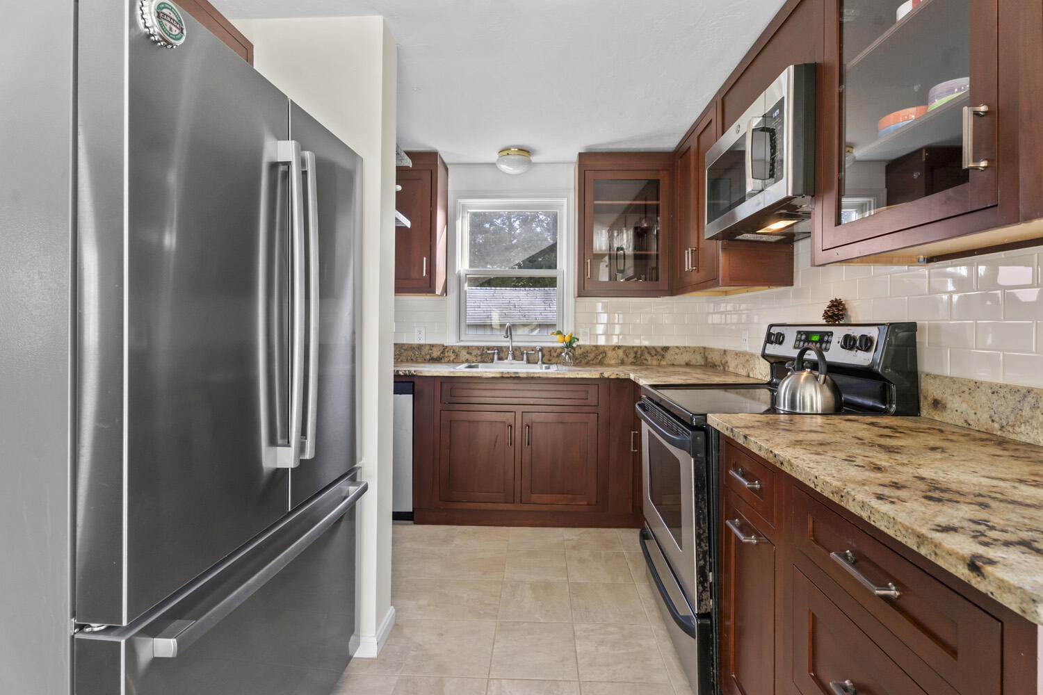60 Saddle Club Road Edgartown, MA 02539 - Photo 9 of 20 a kitchen with stainless steel appliances granite countertop a refrigerator stove and sink