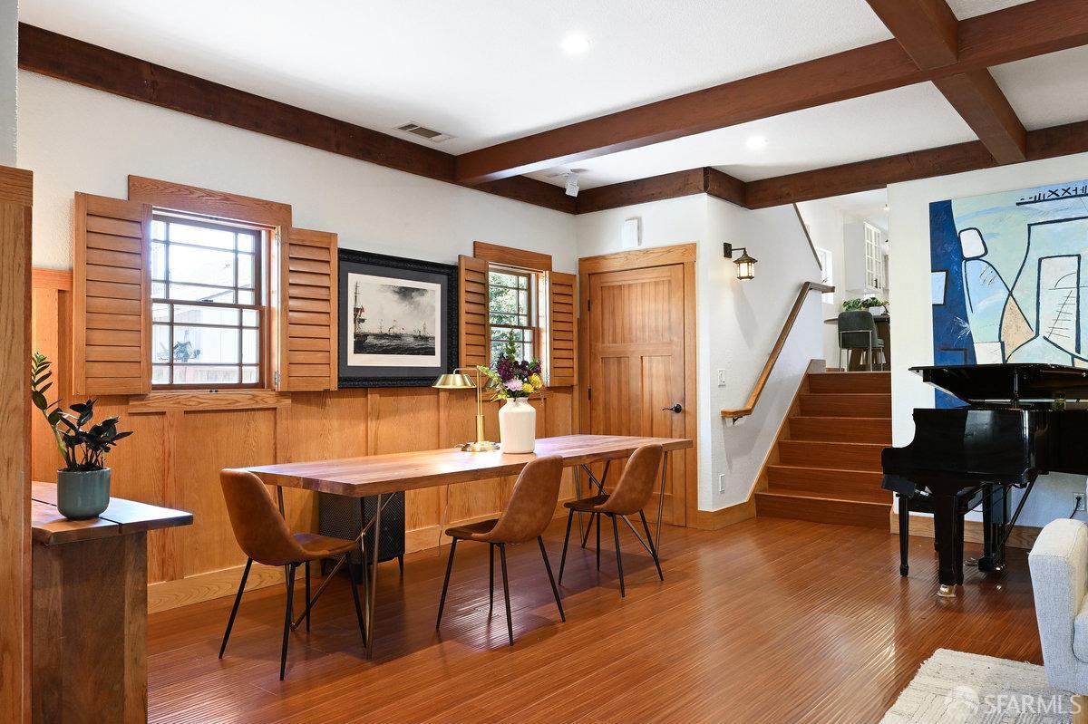 2445 Encinal Avenue Alameda, CA 94501 - Photo 11 of 78 a dining room with wooden floor a chandelier a wooden table and chairs