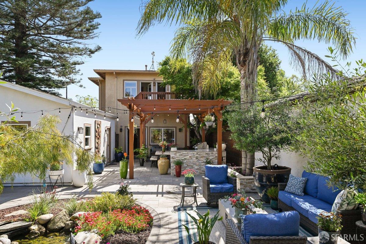 2445 Encinal Avenue Alameda, CA 94501 - Photo 20 of 78 a view of the patio with couches and a table and chairs under an umbrella