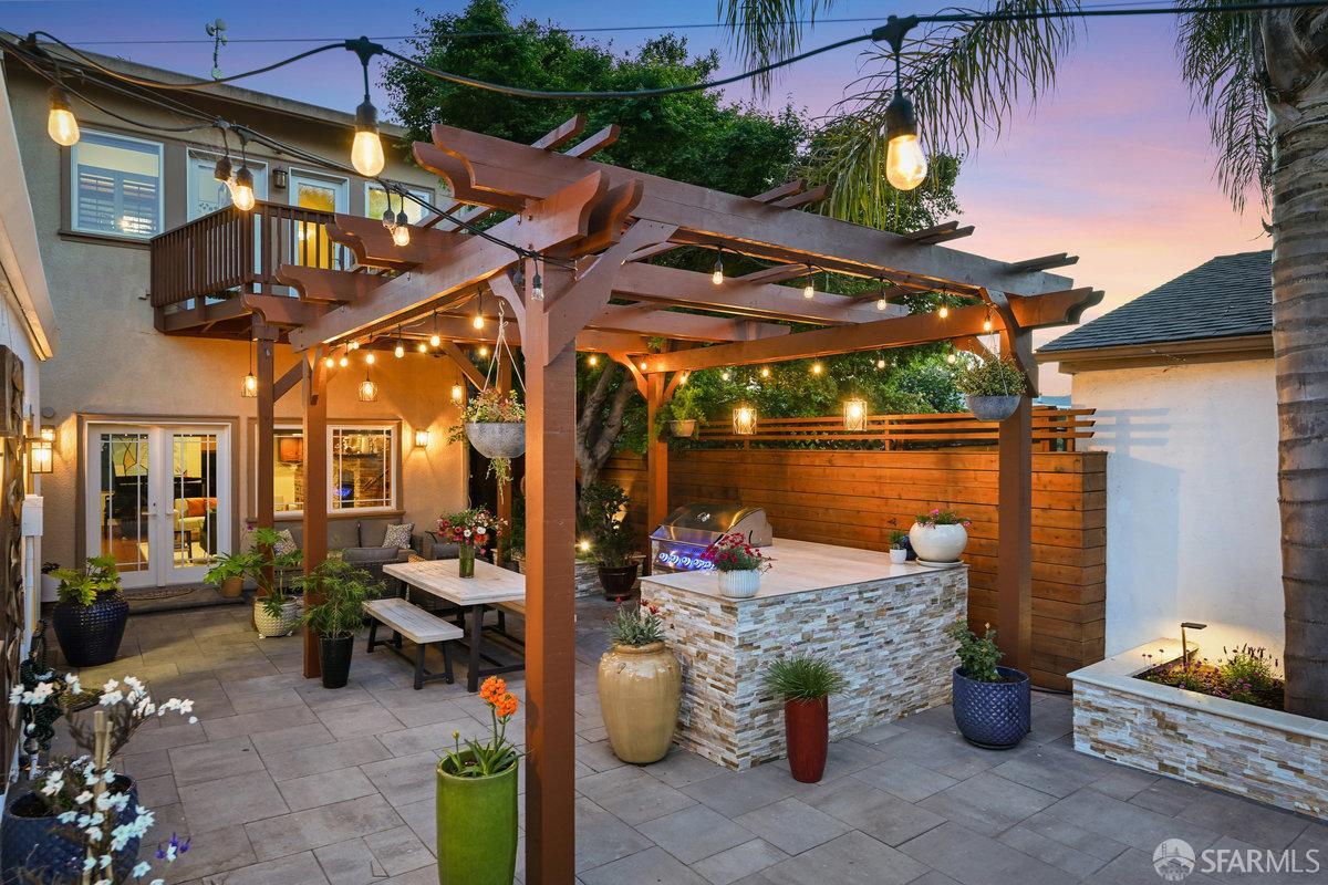 2445 Encinal Avenue Alameda, CA 94501 - Photo 27 of 78 a view of a patio with table and chairs potted plants