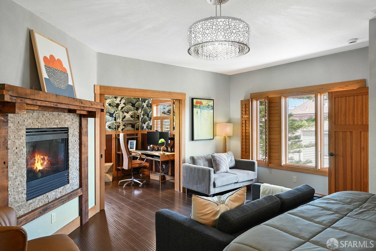 2445 Encinal Avenue Alameda, CA 94501 - Photo 31 of 78 a living room with furniture a chandelier and a fireplace