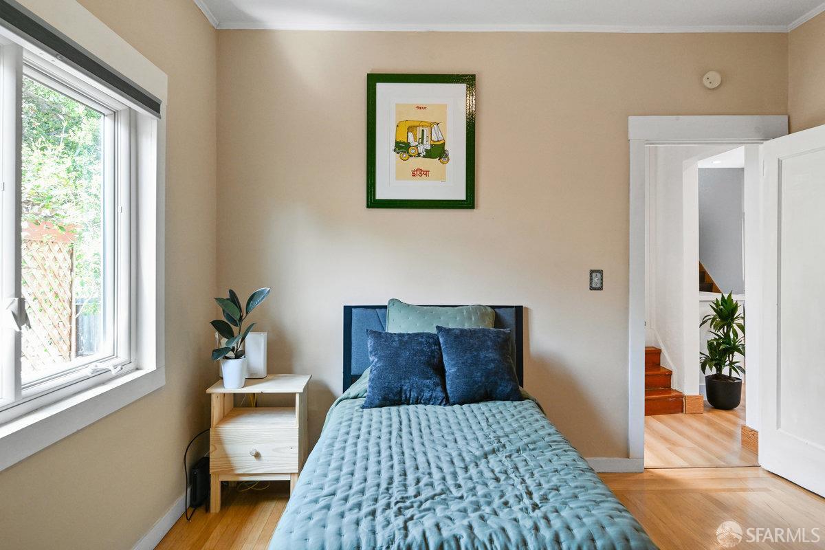2445 Encinal Avenue Alameda, CA 94501 - Photo 43 of 78 a bedroom with a bed and wooden floor