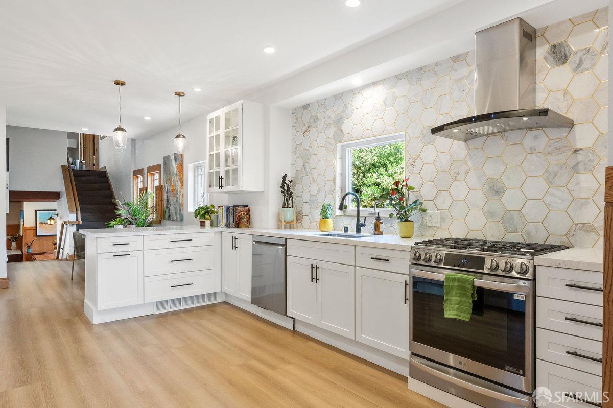 2445 Encinal Avenue Alameda, CA 94501 - Photo 6 of 78 a kitchen with stainless steel appliances white cabinets and a stove