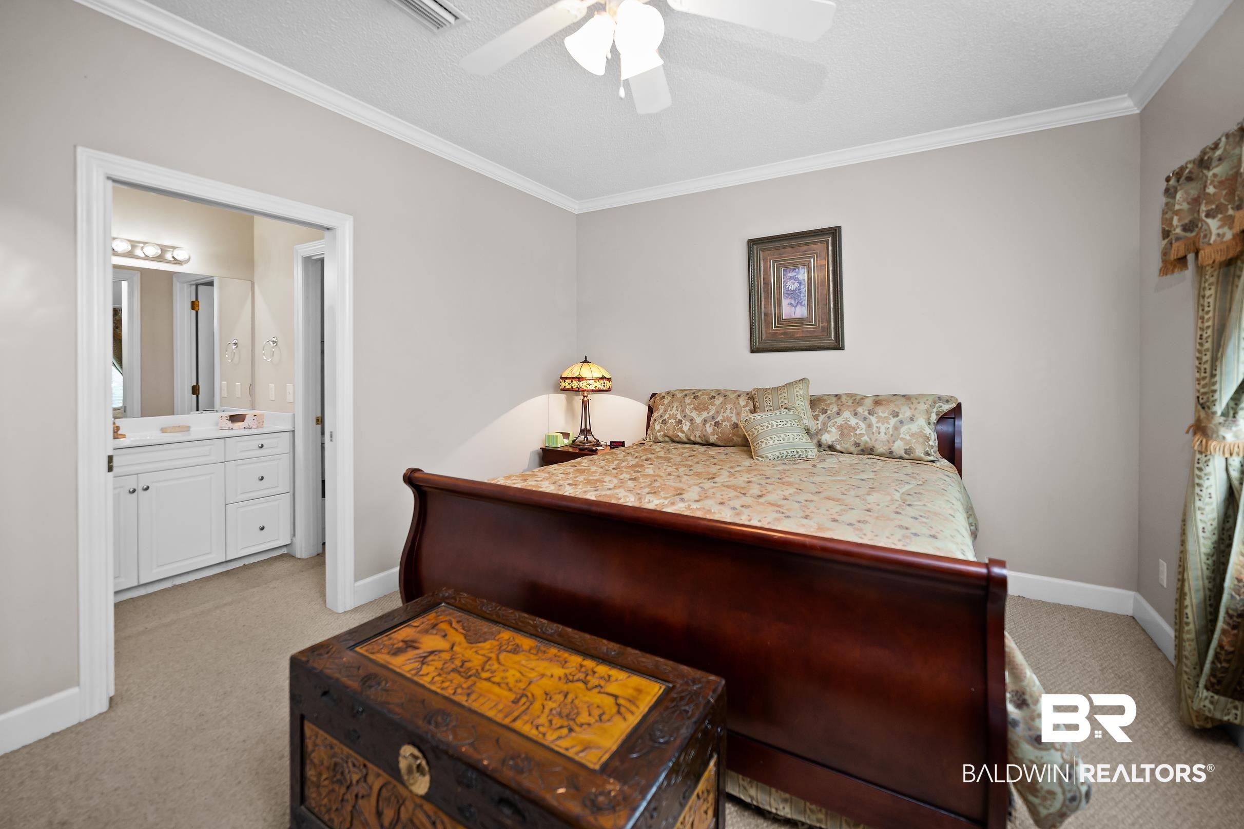 430 West Fort Morgan Road, Unit 704 Gulf Shores, AL 36542 - Photo 13 of 35 Bedroom featuring neutral wall paint, crown molding, and carpet flooring