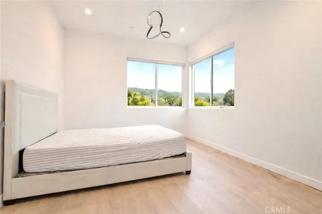 a bedroom with a bed window and walk in closet