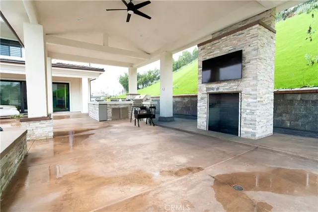 a view of open kitchen with furniture and a fireplace