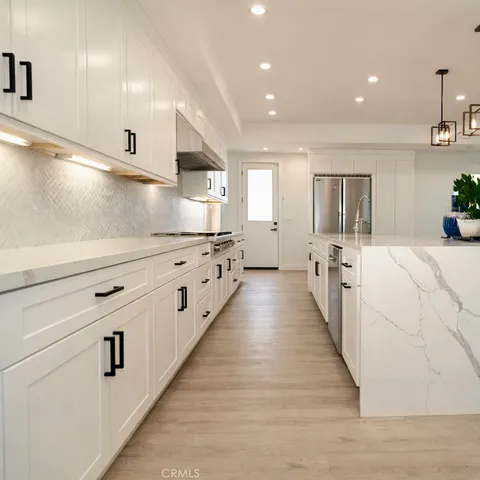 a large white kitchen with lots of counter space