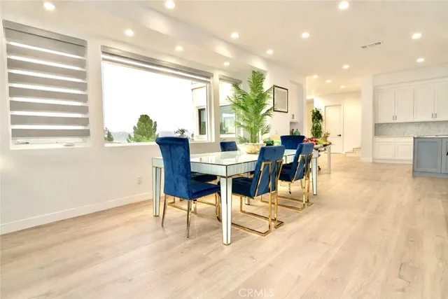 a dining room with furniture and wooden floor