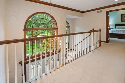 a spacious bedroom with a bed and large windows