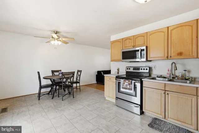 a kitchen with stainless steel appliances granite countertop a stove a sink a microwave and a refrigerator