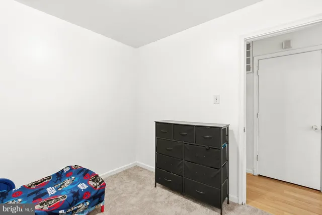a room with a dresser with wooden floor