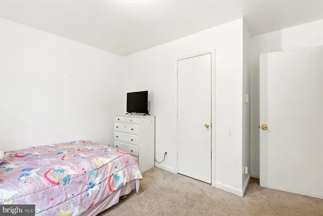 a bedroom with a bed and a tv