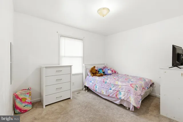 a bedroom with a bed and a dresser