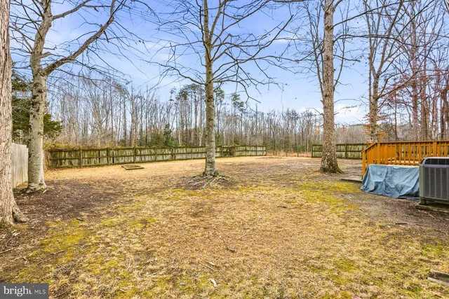 a view of yard with swimming pool and trees