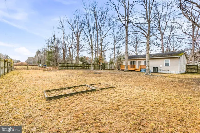 a view of white house with snow on the roadside