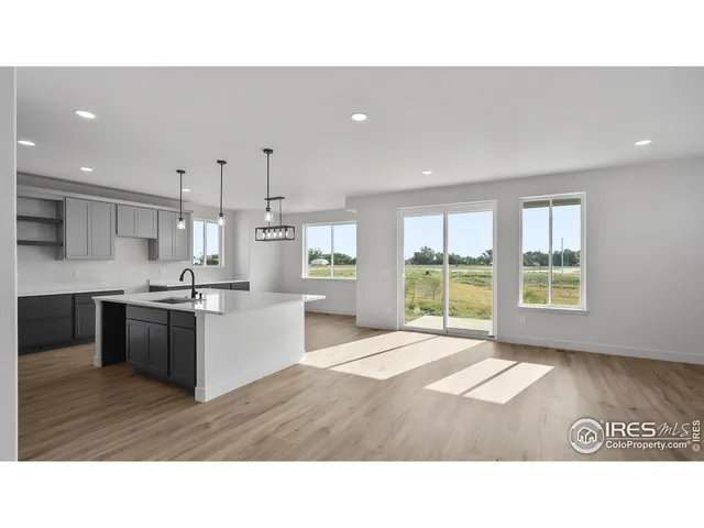 a kitchen with kitchen island a sink stainless steel appliances and cabinets