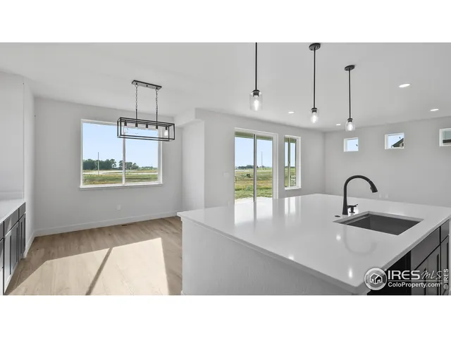 a kitchen with kitchen island a sink stainless steel appliances and cabinets
