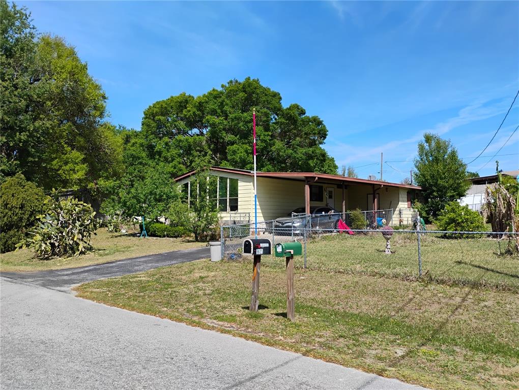 9625 Southeast 170th Lane Summerfield, FL 34491 - Photo 1 of 1 a view of a backyard with table and chairs and a small yard