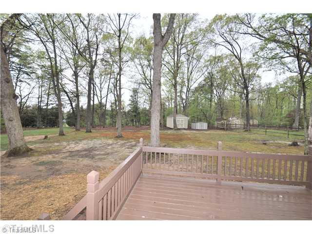 7261 Strawberry Road Summerfield, NC 27358 - Photo 12 of 13 Exterior Back. Spacious lot offers many mature trees, 2 storage buildings and plenty of space for the kids and/or pets to play!