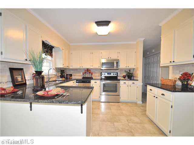 7261 Strawberry Road Summerfield, NC 27358 - Photo 3 of 13 Kitchen. Newly remodeled Kitchen features new granite counters, new stainless steel appliances and new tile backsplash!