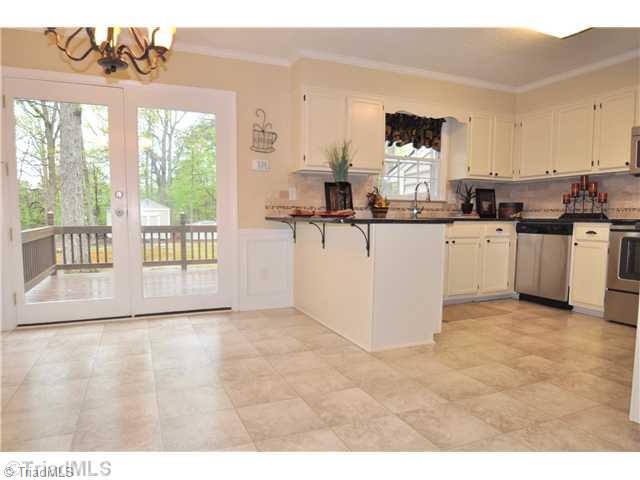 7261 Strawberry Road Summerfield, NC 27358 - Photo 4 of 13 Kitchen. Spacious eat-in Kitchen also offers a granite bar top ideal for pulling up a stool to enjoy an informal meal or to simply hang out. New chair rail and boxes give this space a richer, more elegant look.