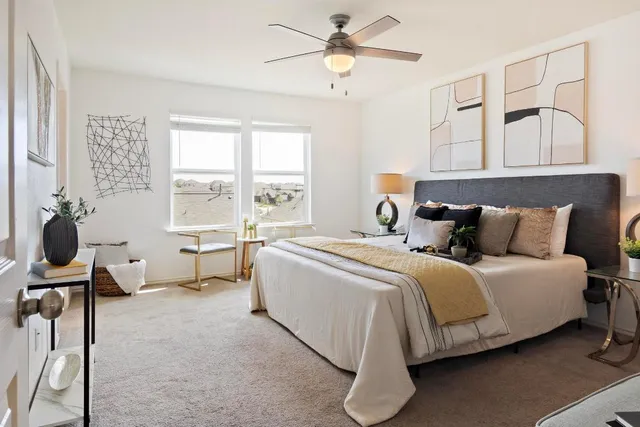 a spacious bedroom with a bed and a window