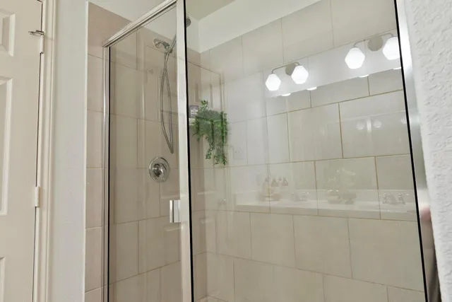 a bathroom with a shower and a mirror