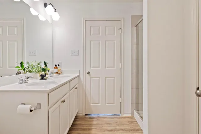 a bathroom with a sink vanity and a mirror