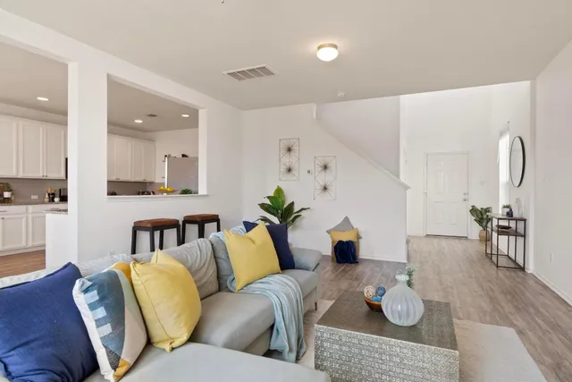 a living room with furniture and wooden floor