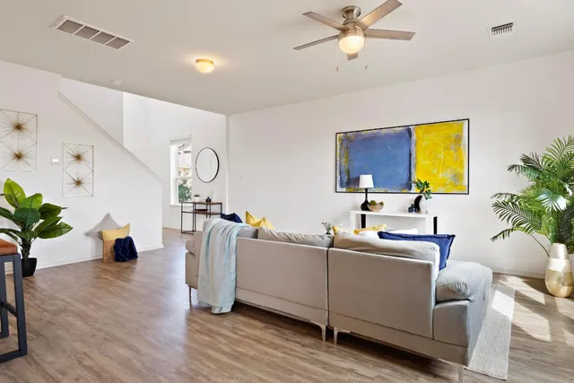 a living room with furniture and a potted plant