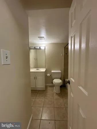 a white toilet sitting next to a bath tub and a shower