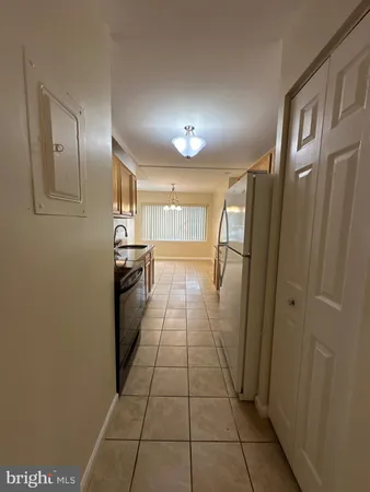 a kitchen with a sink a stove and cabinets