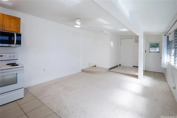 a view of a kitchen with microwave and cabinets