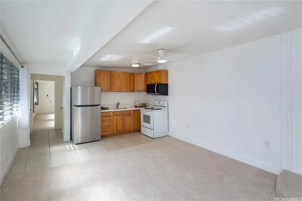 a kitchen with stainless steel appliances a refrigerator sink and microwave