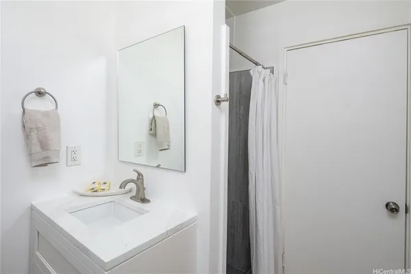 a bathroom with a sink vanity and a mirror