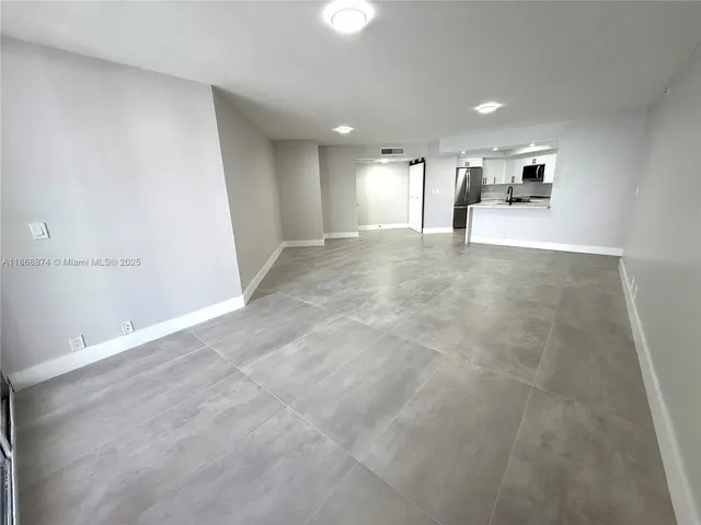 a view of a big room with closet and windows