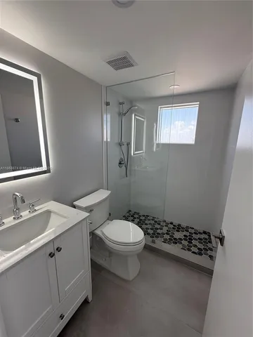 a bathroom with a sink toilet and shower