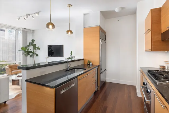 a living room with furniture a counter space and a dining table with kitchen view