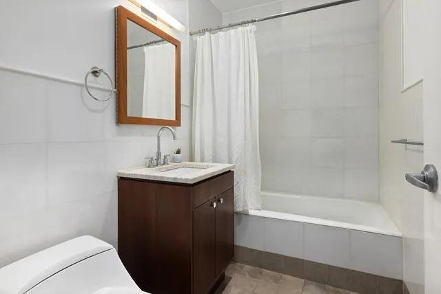 a large bed sitting in a bedroom next to a window