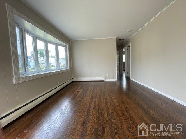 57 Corey Street Fords, NJ 08863 - Photo 4 of 18 a view of an empty room with wooden floor and a window