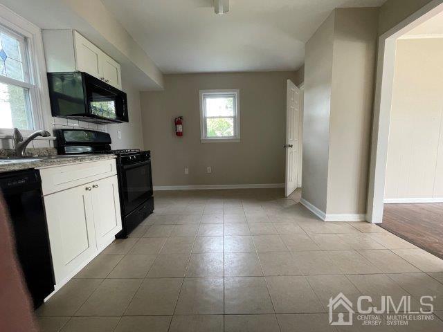 57 Corey Street Fords, NJ 08863 - Photo 8 of 18 a kitchen with stainless steel appliances granite countertop a refrigerator and a stove top oven