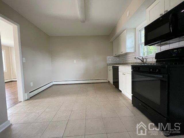 57 Corey Street Fords, NJ 08863 - Photo 9 of 18 a kitchen with a stove and a microwave