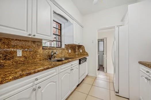 4144 Alton Road Miami Beach, FL 33140 - Photo 17 of 49 a kitchen with granite countertop a sink and cabinets