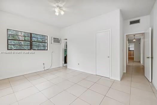 4144 Alton Road Miami Beach, FL 33140 - Photo 20 of 49 an empty room with a empty space and windows