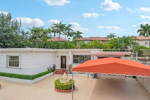 4144 Alton Road Miami Beach, FL 33140 - Photo 2 of 49 a view of a swimming pool with an outdoor space