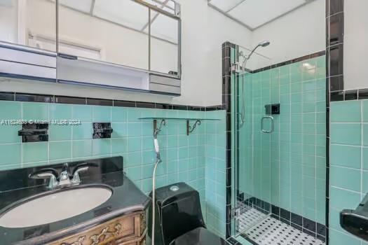 4144 Alton Road Miami Beach, FL 33140 - Photo 22 of 49 a bathroom with a sink a toilet and shower