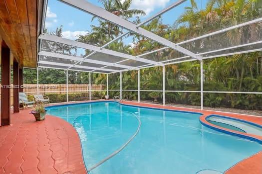 4144 Alton Road Miami Beach, FL 33140 - Photo 28 of 49 a view of swimming pool with large trees and plants
