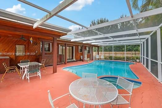 4144 Alton Road Miami Beach, FL 33140 - Photo 30 of 49 a backyard of a house with table and chairs
