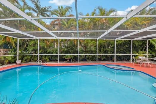 4144 Alton Road Miami Beach, FL 33140 - Photo 34 of 49 a view of a swimming pool with a yard and potted plants